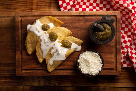 Fried quesadillas. Traditional Mexican appetizer "garnacha". Deep Fried handmade corn tortilla that can be filled with a wide variety of ingredients, cheese, pork rinds, meat, etc.の写真素材