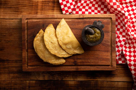 Fried quesadillas. Traditional Mexican appetizer "garnacha". Deep Fried handmade corn tortilla that can be filled with a wide variety of ingredients, cheese, pork rinds, meat, etc.の写真素材