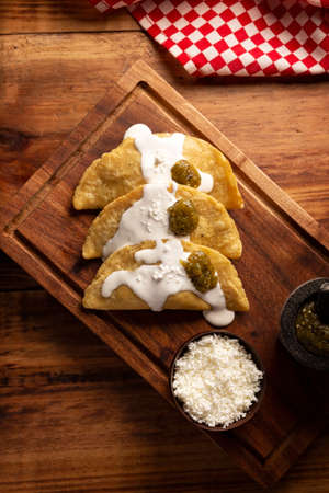 Fried quesadillas. Traditional Mexican appetizer "garnacha". Deep Fried handmade corn tortilla that can be filled with a wide variety of ingredients, cheese, pork rinds, meat, etc.の写真素材