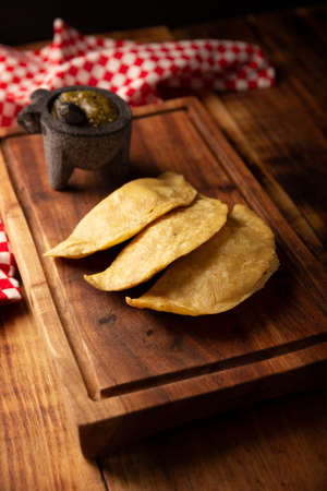 Fried quesadillas. Traditional Mexican appetizer "garnacha". Deep Fried handmade corn tortilla that can be filled with a wide variety of ingredients, cheese, pork rinds, meat, etc.の写真素材