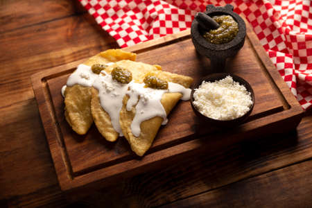 Fried quesadillas. Traditional Mexican appetizer "garnacha". Deep Fried handmade corn tortilla that can be filled with a wide variety of ingredients, cheese, pork rinds, meat, etc.の写真素材