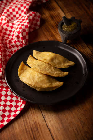 Fried quesadillas. Traditional Mexican appetizer "garnacha". Deep Fried handmade corn tortilla that can be filled with a wide variety of ingredients, cheese, pork rinds, meat, etc.の写真素材