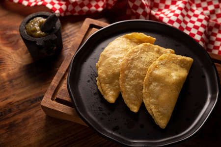 Fried quesadillas. Traditional Mexican appetizer "garnacha". Deep Fried handmade corn tortilla that can be filled with a wide variety of ingredients, cheese, pork rinds, meat, etc.の写真素材