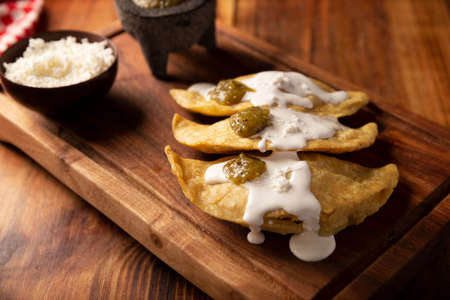 Fried quesadillas. Traditional Mexican appetizer "garnacha". Deep Fried handmade corn tortilla that can be filled with a wide variety of ingredients, cheese, pork rinds, meat, etc.の写真素材