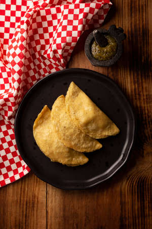 Fried quesadillas. Traditional Mexican appetizer "garnacha". Deep Fried handmade corn tortilla that can be filled with a wide variety of ingredients, cheese, pork rinds, meat, etc.の写真素材