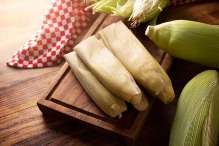 Tamales de Elote, also called Uchepos. Typical Mexican dish. Can be served with green salsa and accompanied by sour cream or served as a dessert covered with caramel or any other sweet toppingの写真素材
