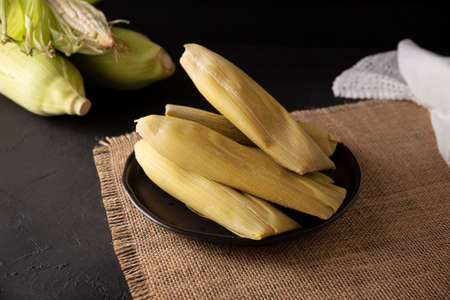 Tamales de Elote, also called Uchepos. Typical Mexican dish. Can be served with green salsa and accompanied by sour cream or served as a dessert covered with caramel or any other sweet toppingの写真素材