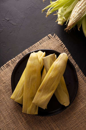 Tamales de Elote, also called Uchepos. Typical Mexican dish. Can be served with green salsa and accompanied by sour cream or served as a dessert covered with caramel or any other sweet toppingの写真素材