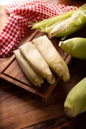 Tamales de Elote, also called Uchepos. Typical Mexican dish. Can be served with green salsa and accompanied by sour cream or served as a dessert covered with caramel or any other sweet toppingの写真素材