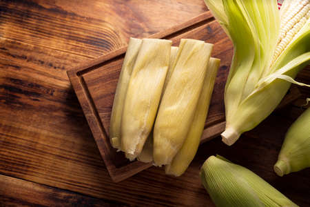 Tamales de Elote, also called Uchepos. Typical Mexican dish. Can be served with green salsa and accompanied by sour cream or served as a dessert covered with caramel or any other sweet toppingの写真素材