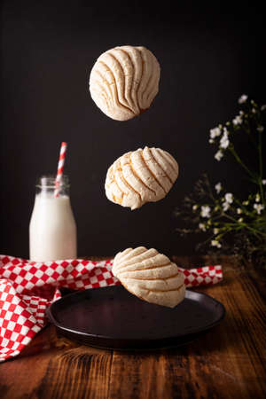 levitating shells. Mexican sweet bread roll with seashell-like appearance, Usually eaten with coffee or hot chocolate at breakfast or as an afternoon snack.の写真素材