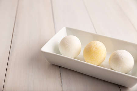 Homemade ice cream Mochis. Traditional Japanese dessert made from rice flour. Close up on white wooden surface with copy space.の写真素材