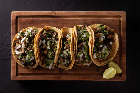 Tacos from Suadero. Fried meat in a corn tortilla. Street food from CDMX, Mexico, traditionally accompanied with cilantro, onion and spicy red sauceの写真素材