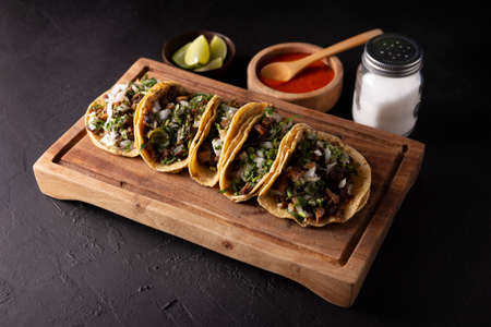 Tacos from Suadero. Fried meat in a corn tortilla. Street food from CDMX, Mexico, traditionally accompanied with cilantro, onion and spicy red sauceの写真素材