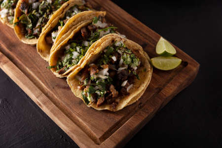 Tacos from Suadero. Fried meat in a corn tortilla. Street food from CDMX, Mexico, traditionally accompanied with cilantro, onion and spicy red sauceの写真素材