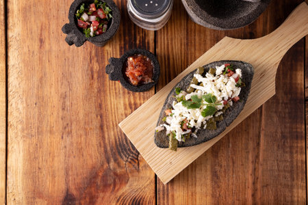 Tlacoyo with Nopales and Cheese. Mexican pre hispanic dish made of blue corn flour patty filled with fried beans. Popular street food in Mexico. Top view.の写真素材