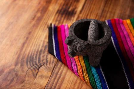 Molcajete. Traditional mexican version of mortar and pestle handmade of volcanic stone. Essential element in the preparation of the authentic Mexican sauce and other dishes.の写真素材