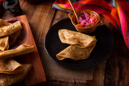Golden quesadillas. Fried quesadillas made with corn tortillas, they can be filled with any dish or ingredient, such as meat, potato or fish such as marlin or tuna, popular during the Lenten season.の写真素材