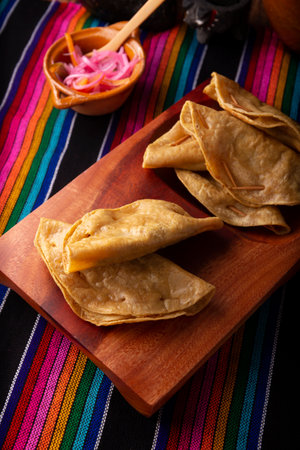 Golden quesadillas. Fried quesadillas made with corn tortillas, they can be filled with any dish or ingredient, such as meat, potato or fish such as marlin or tuna, popular during the Lenten season.の写真素材