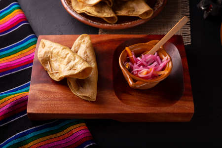 Golden quesadillas. Fried quesadillas made with corn tortillas, they can be filled with any dish or ingredient, such as meat, potato or fish such as marlin or tuna, popular during the Lenten season.の写真素材