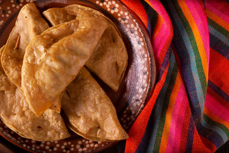 Golden quesadillas. Fried quesadillas made with corn tortillas, they can be filled with any dish or ingredient, such as meat, potato or fish such as marlin or tuna, popular during the Lenten season.の写真素材