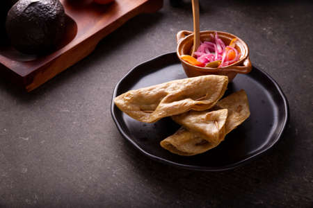 Golden quesadillas. Fried quesadillas made with corn tortillas, they can be filled with any dish or ingredient, such as meat, potato or fish such as marlin or tuna, popular during the Lenten season.の写真素材