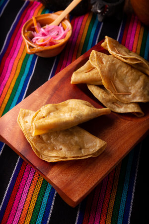 Golden quesadillas. Fried quesadillas made with corn tortillas, they can be filled with any dish or ingredient, such as meat, potato or fish such as marlin or tuna, popular during the Lenten season.の写真素材