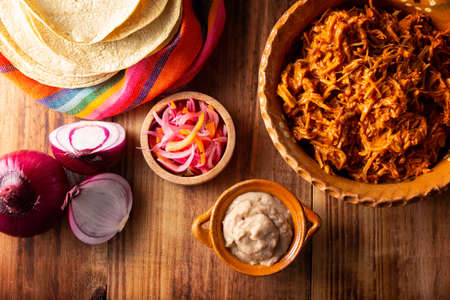 Cochinita pibil. Typical Mexican stew from Merida, Yucatan, made from pork marinated with achiote and generally accompanied with beans and red onion with habanero chili, it can be eaten in tacos.の写真素材