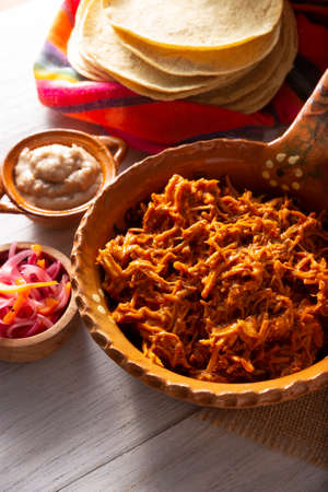 Cochinita pibil. Typical Mexican stew from Merida, Yucatan, made from pork marinated with achiote and generally accompanied with beans and red onion with habanero chili, it can be eaten in tacos.の写真素材