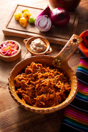 Cochinita pibil. Typical Mexican stew from Merida, Yucatan, made from pork marinated with achiote and generally accompanied with beans and red onion with habanero chili, it can be eaten in tacos.の写真素材