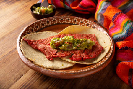 Cecina Enchilada Tacos with Guacamole. Salted, sun-dried pork or beef meat, seasoned with various spices and chili peppers, usually eaten in tacosの写真素材