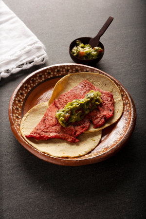 Cecina Enchilada Tacos with Guacamole. Salted, sun-dried pork or beef meat, seasoned with various spices and chili peppers, usually eaten in tacosの写真素材
