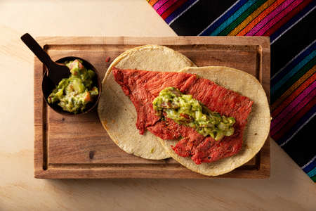 Cecina Enchilada Tacos with Guacamole. Salted, sun-dried pork or beef meat, seasoned with various spices and chili peppers, usually eaten in tacosの写真素材