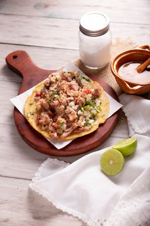 Taco of Carnitas. Cornmeal tortilla with deep fried pork. Traditional Mexican appetizer commonly accompanied by cilantro, onion and hot sauce.の写真素材