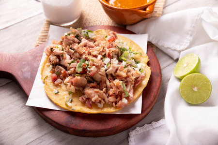 Taco of Carnitas. Cornmeal tortilla with deep fried pork. Traditional Mexican appetizer commonly accompanied by cilantro, onion and hot sauce.の写真素材