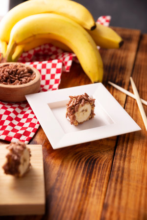 Banana sushi sweet rolls with caramel, peanut butter and chocolate puffed rice. Funny and easy homemade snack for kids and adults.の写真素材
