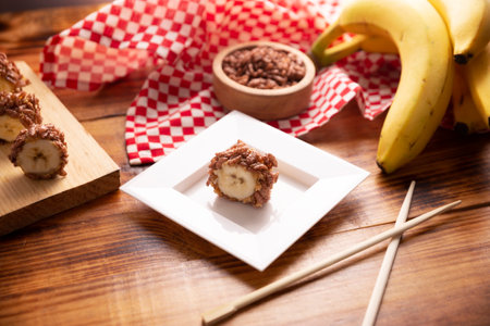 Banana sushi sweet rolls with caramel, peanut butter and chocolate puffed rice. Funny and easy homemade snack for kids and adults.の写真素材
