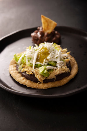Chicken soup. Traditional homemade Mexican appetizer prepared with fried corn dough covered with...