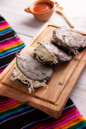 Chubby pork rind. Blue Cornmeal dough stuffed with chicharron prenado. Traditional Mexican appetizer commonly accompanied by cilantro, onion and hot sauce.の写真素材