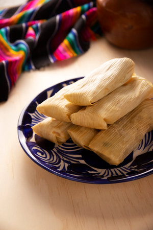 Tamales. Prehispanic dish typical of Mexico and some Latin American countries. Corn dough wrapped in corn leaves. The tamales are steamed.の写真素材