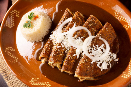 Chicken enmoladas. Also known as mole poblano enchiladas, they are a typical Mexican dish that is very popular in Mexico and the rest of the world.の写真素材