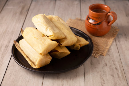 Tamales. Prehispanic dish typical of Mexico and some Latin American countries. Corn dough wrapped in corn leaves. The tamales are steamed.の写真素材