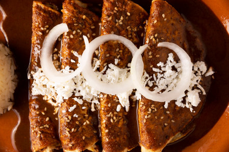 Chicken enmoladas. Also known as mole poblano enchiladas, they are a typical Mexican dish that is very popular in Mexico and the rest of the world. Table top view.の写真素材