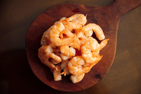 Boiled and peeled shrimp, ready to eat or used as an ingredient in salads, cocktails, toasts and many more recipes. Table top view.の写真素材