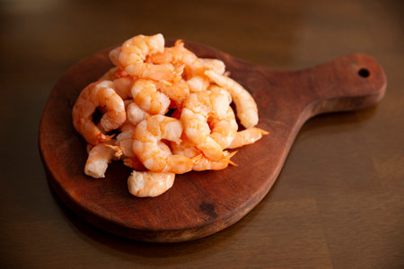 Boiled and peeled shrimp, ready to eat or used as an ingredient in salads, cocktails, toasts and many more recipes. Table top view.の写真素材