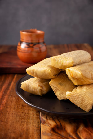 Tamales. Prehispanic dish typical of Mexico and some Latin American countries. Corn dough wrapped in corn leaves. The tamales are steamed.の写真素材