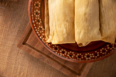 Tamales. Prehispanic dish typical of Mexico and some Latin American countries. Corn dough wrapped in corn leaves. The tamales are steamed.の写真素材