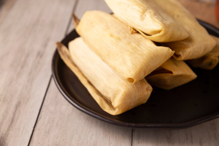 Tamales. Prehispanic dish typical of Mexico and some Latin American countries. Corn dough wrapped in corn leaves. The tamales are steamed.の写真素材