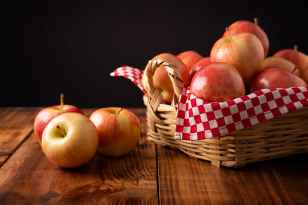 Several Royal Gala Apples (malus domestica) on wooden rustic table. Apple trees are cultivated worldwide and are the most widely used species of the genus Malus.の写真素材