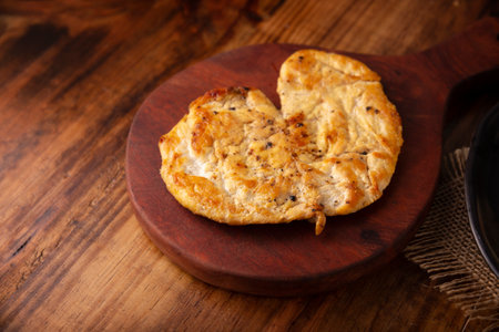 Homemade grilled chicken breast, flattened and seasoned on rustic wooden table. Closeup image.の写真素材